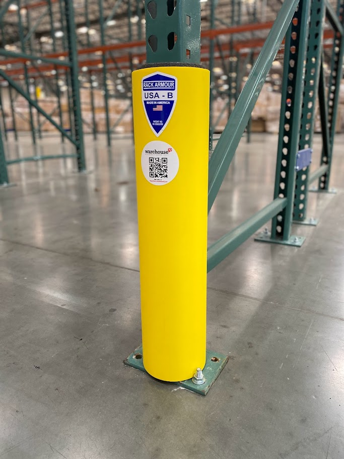 a yellow rack protector in the middle of a Los Angeles warehouse protecting pallet racking